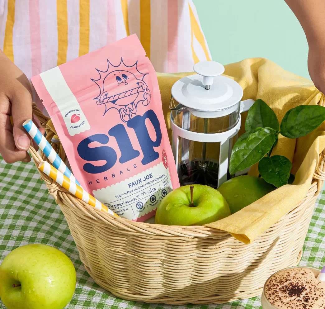 Basket filled with Peppermint Mocha Coffee Alternative, apples, straws and a french press