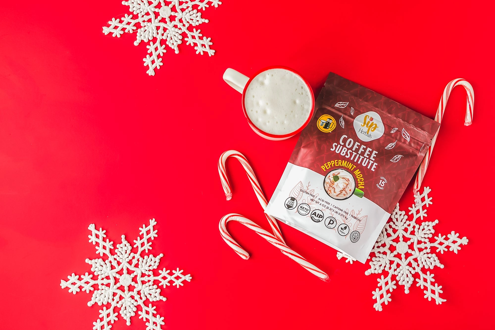 Sip Herbals Peppermint Mocha bag beside candy canes on a red backdrop
