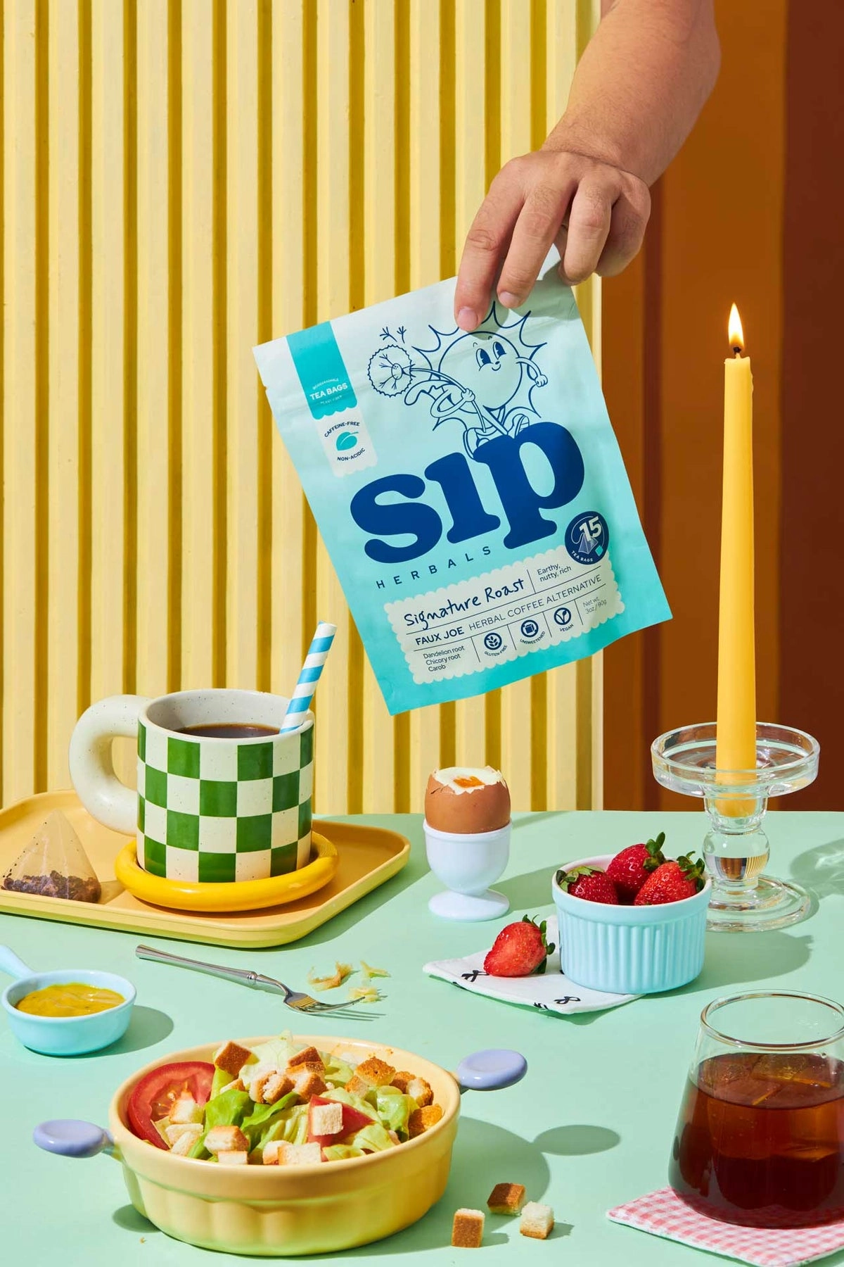 Sip Herbals Signature Roast tea bags beside a breakfast spread on a colorful table